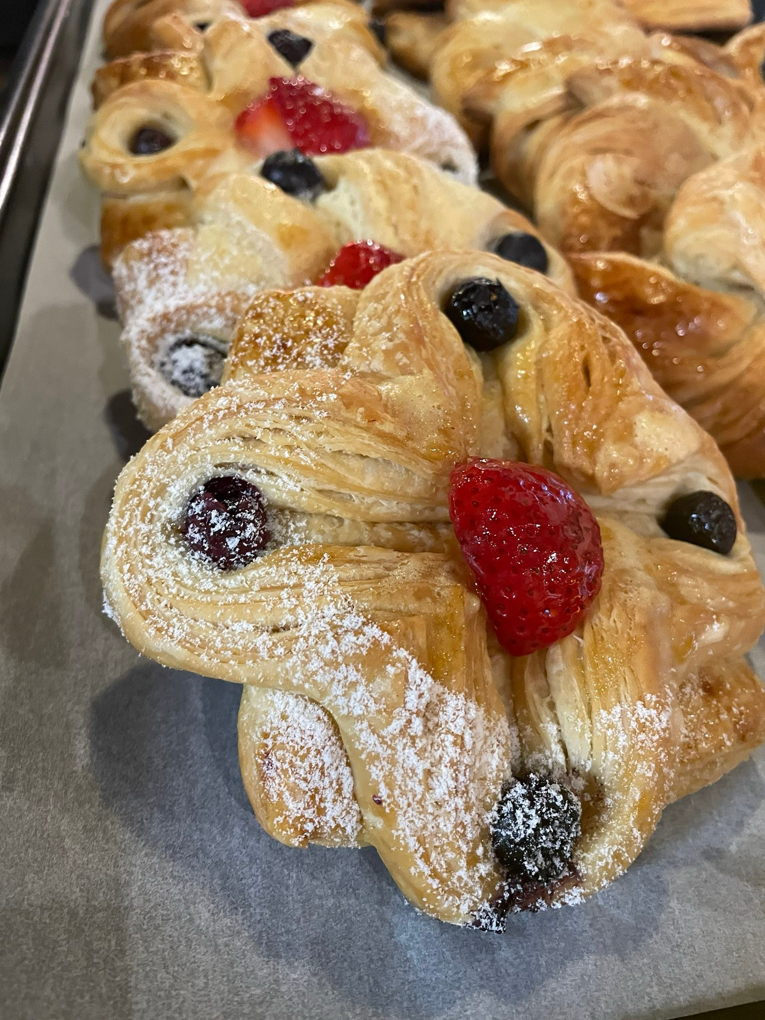 Berry-stuffed Danish dusted with powdered sugar