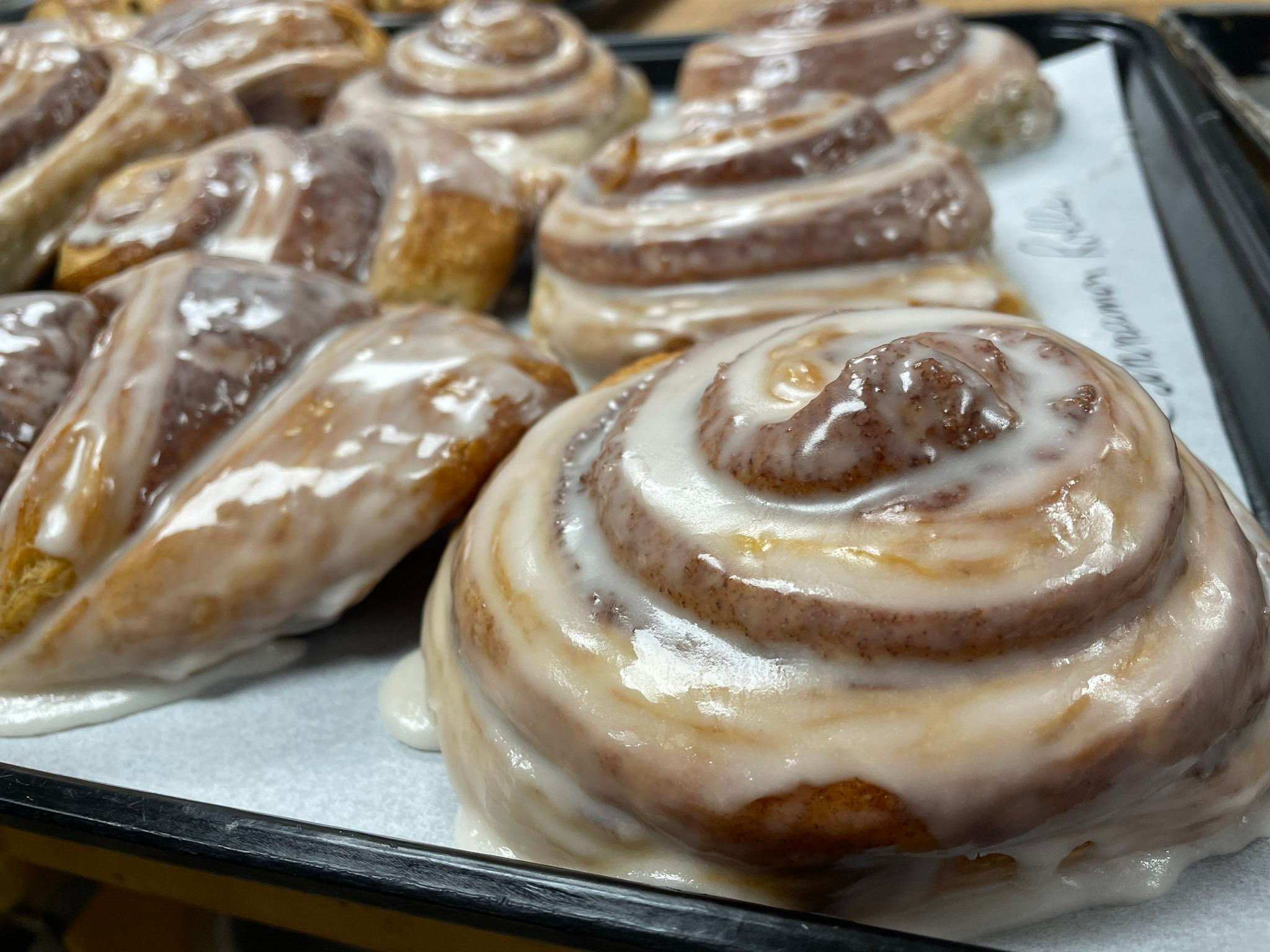 Glazed cinnamon rolls in a baking pan