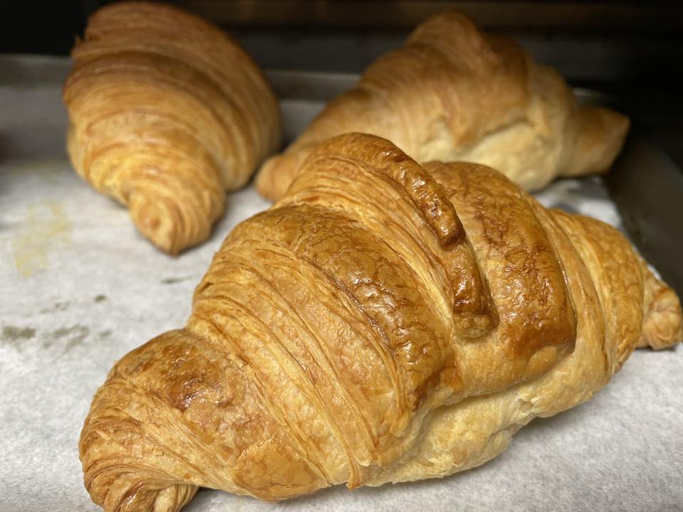 Close-up of golden, laminated croissants fresh from the oven